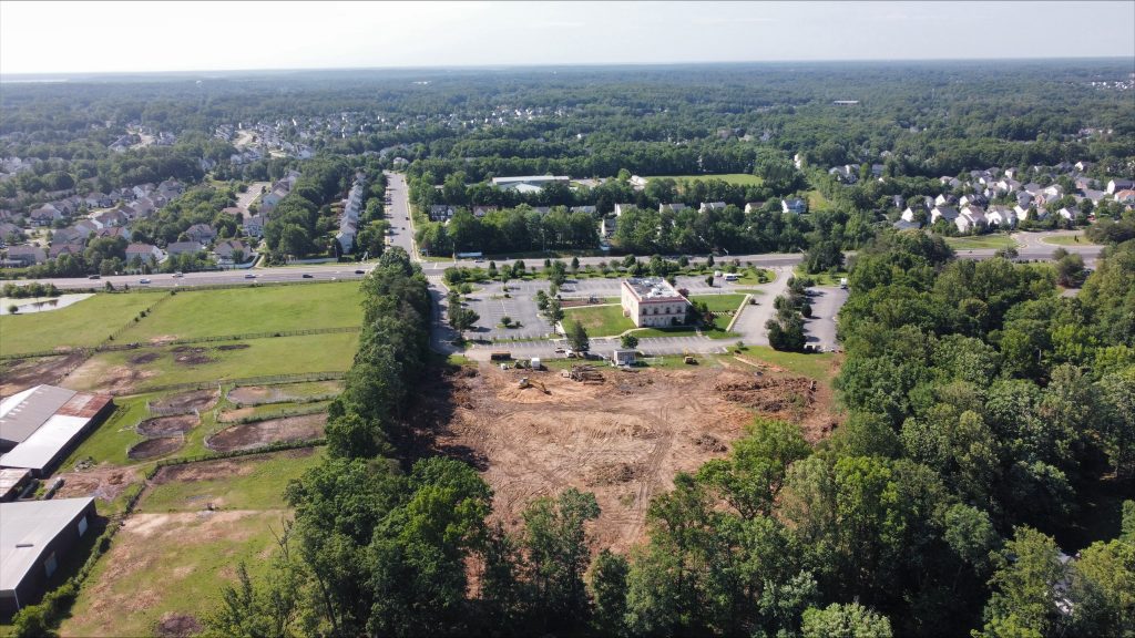 Cleared work area with heavy equipment during Phase 1 site work in June 2026