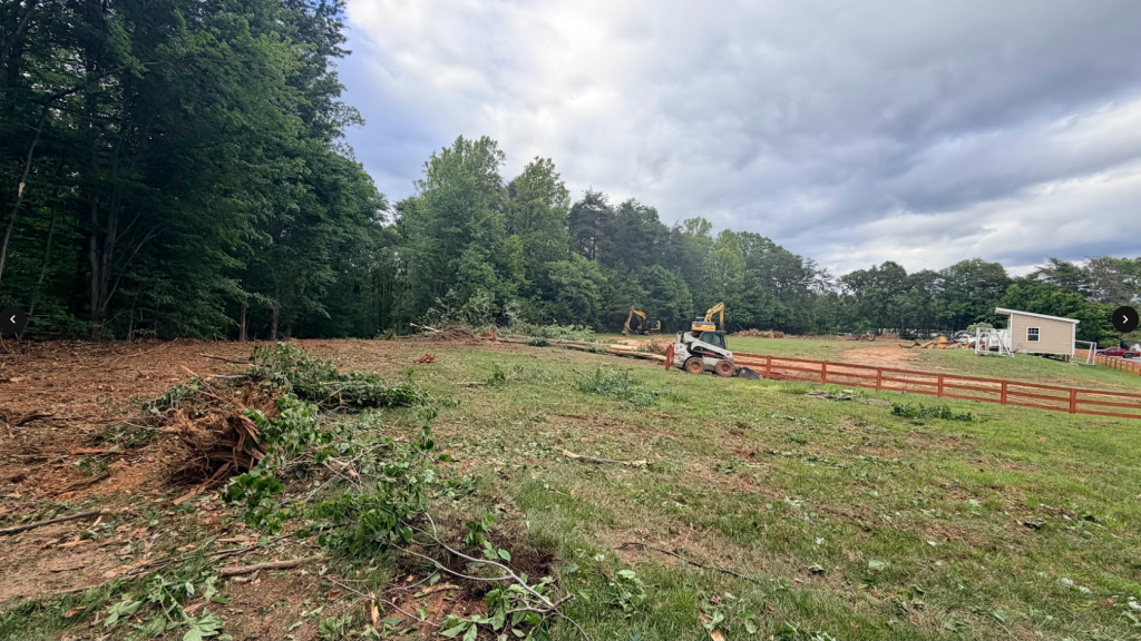 Heavy equipment clearing trees and brush on the expansion site, view 2